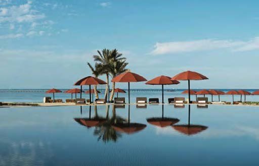 Parasols reflected in an infinity pool